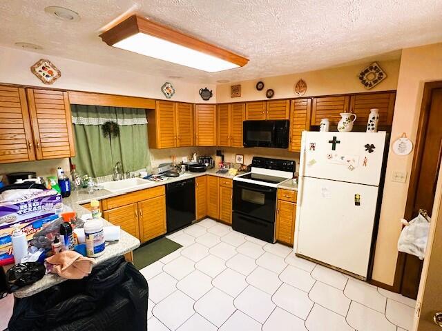 326 Somerset Dr, East Stroudsburg, PA 18301 - kitchen with black appliances, a sink, light countertops, a textured ceiling, and brown cabinetry