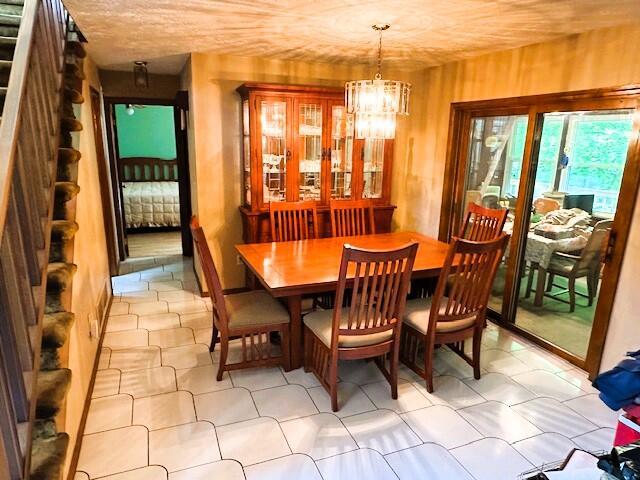 326 Somerset Dr, East Stroudsburg, PA 18301 - dining room featuring stairway, a chandelier, and light floors