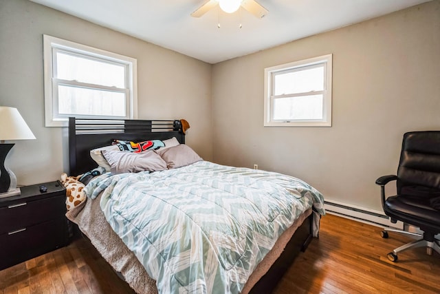 1553 Locust Ln, Pocono Lake, PA 18347 - bedroom with wood-type flooring, multiple windows, a baseboard heating unit, and a ceiling fan