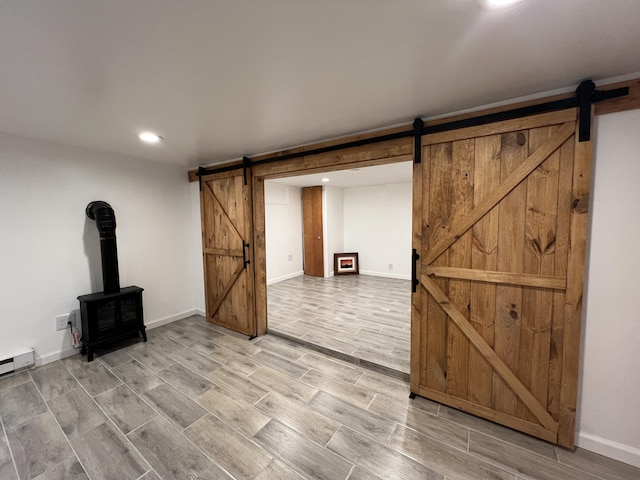 1553 Locust Ln, Pocono Lake, PA 18347 - unfurnished living room featuring a barn door, a wood stove, light wood-style floors, and recessed lighting