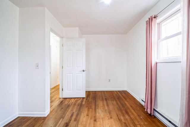 1553 Locust Ln, Pocono Lake, PA 18347 - spare room featuring baseboard heating and hardwood / wood-style floors