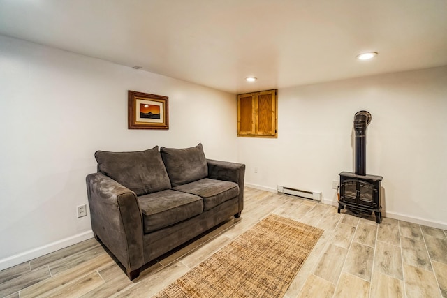 1553 Locust Ln, Pocono Lake, PA 18347 - living room featuring a baseboard radiator, light wood-style floors, recessed lighting, and a wood stove