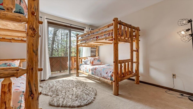 bedroom with access to exterior, carpet, and baseboards