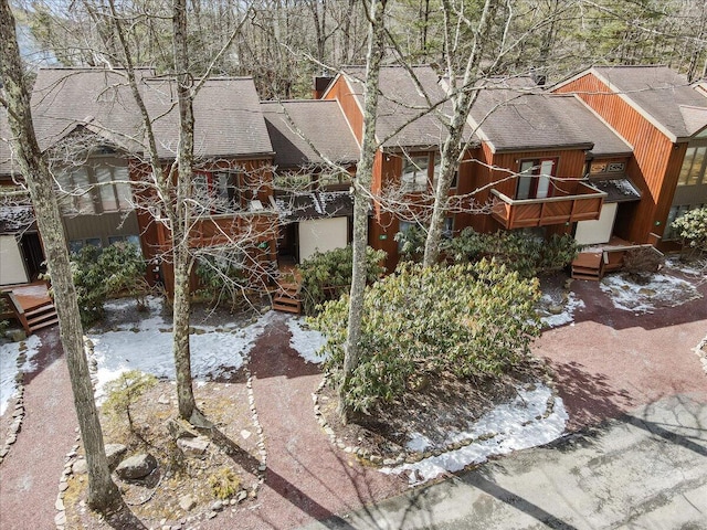 view of side of property with a shingled roof