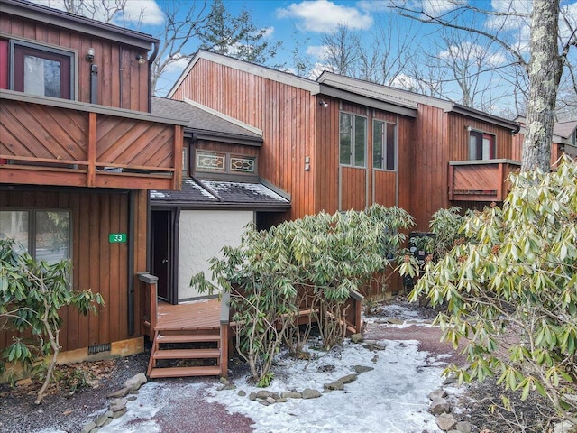 exterior space featuring crawl space and roof with shingles