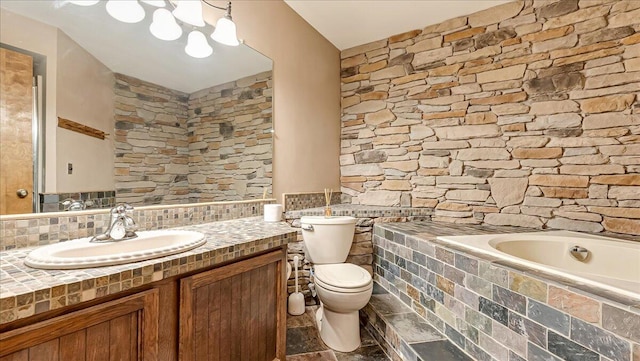 full bath with tasteful backsplash, toilet, vanity, and tiled tub