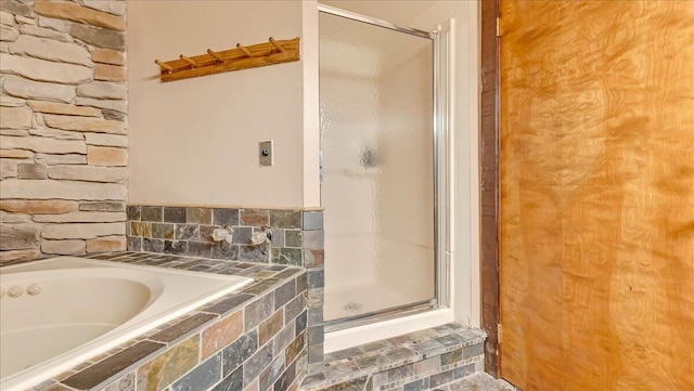 full bathroom featuring a garden tub and a stall shower