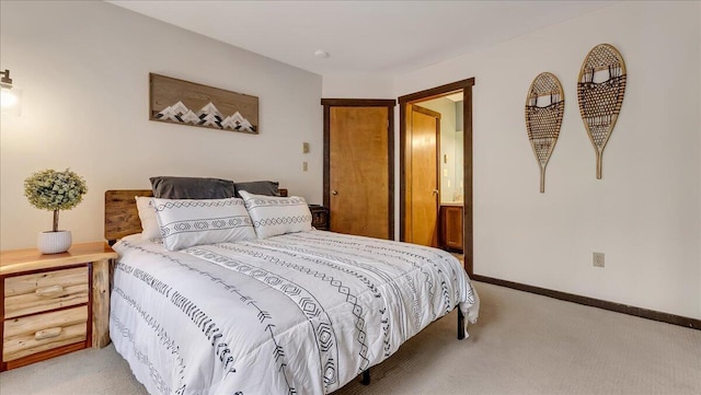 bedroom with baseboards and light carpet