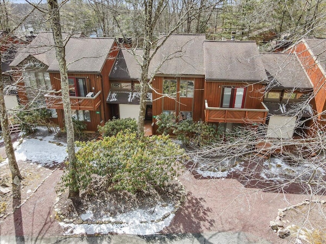 rustic home with a shingled roof