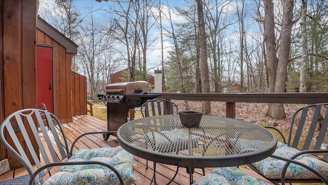 deck with area for grilling and outdoor dining area