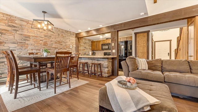 dining room featuring an inviting chandelier and light wood-style flooring