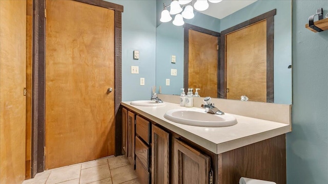 full bathroom with a sink, double vanity, and tile patterned floors