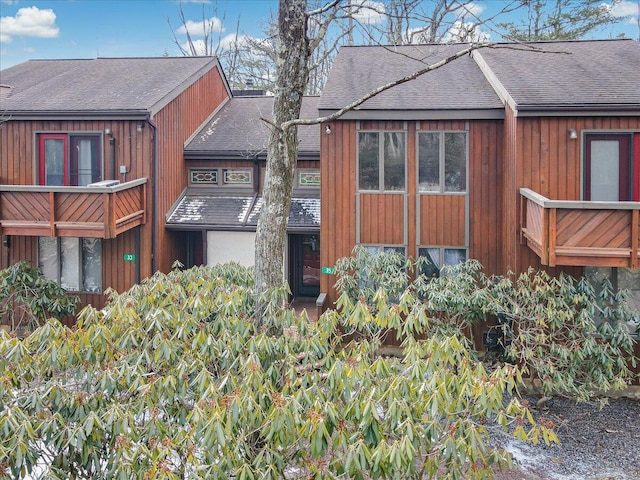 view of side of home featuring a shingled roof