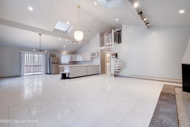 unfurnished living room with light tile patterned flooring, high vaulted ceiling, a skylight, a baseboard radiator, and sink