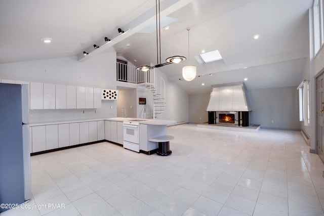 kitchen with white range with electric stovetop, a skylight, decorative light fixtures, white cabinets, and stainless steel fridge