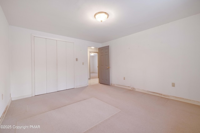 unfurnished bedroom with carpet and a closet