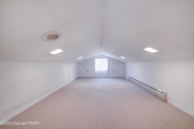 bonus room featuring a baseboard radiator, lofted ceiling, and light carpet