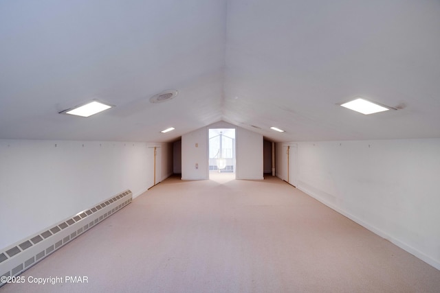 bonus room with a baseboard radiator, vaulted ceiling, and light carpet