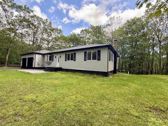 248 Seneca Dr, Milford, PA 18337 - rear view of property featuring an attached garage, a chimney, and a yard