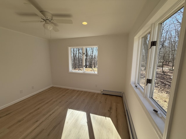 248 Seneca Dr, Milford, PA 18337 - spare room featuring plenty of natural light, a baseboard radiator, wood finished floors, and recessed lighting