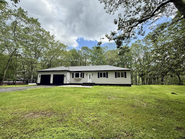 248 Seneca Dr, Milford, PA 18337 - view of front facade with a garage, asphalt driveway, a front lawn, a chimney, and view of wooded area
