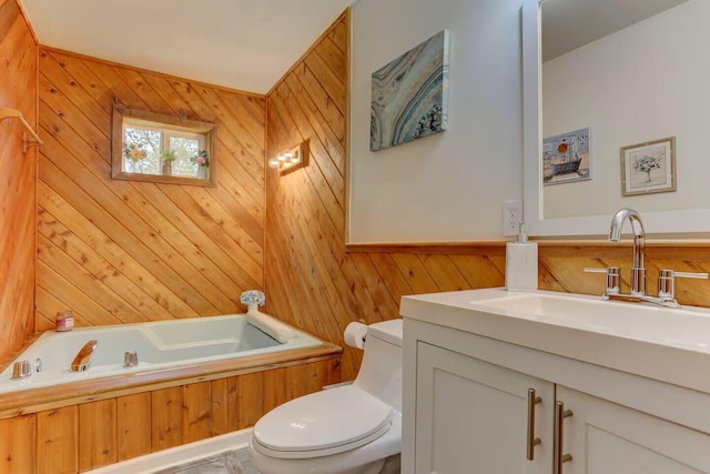 bathroom featuring vanity, toilet, a tub, and wood walls