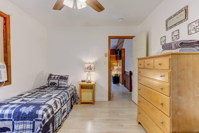 bedroom with baseboards, ceiling fan, and light wood finished floors