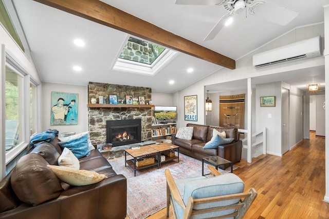 104 Jimmy Pond Ct, Pocono Pines, PA 18350 - living area featuring a wall unit AC, light wood-style floors, a ceiling fan, a stone fireplace, and a skylight