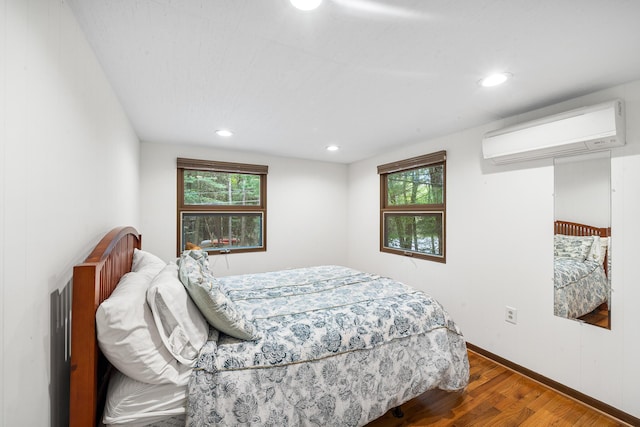 104 Jimmy Pond Ct, Pocono Pines, PA 18350 - bedroom with a wall mounted AC, wood finished floors, multiple windows, recessed lighting, and baseboards