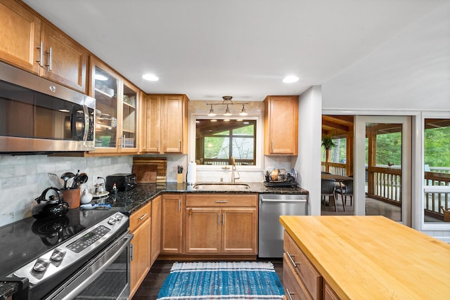 104 Jimmy Pond Ct, Pocono Pines, PA 18350 - kitchen with stainless steel appliances, a sink, wooden counters, decorative backsplash, and glass insert cabinets
