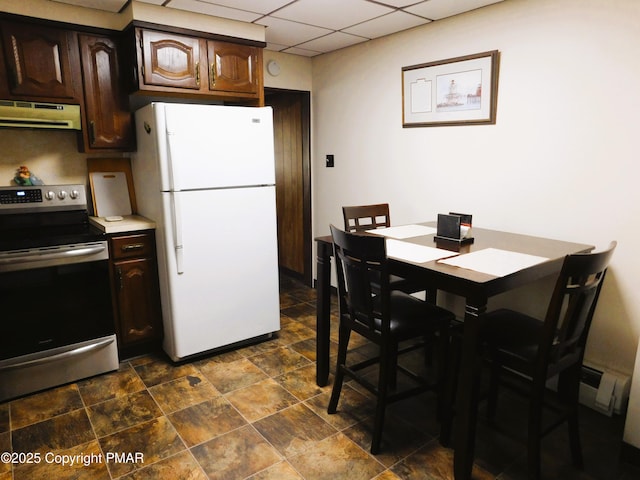 kitchen featuring a drop ceiling, dark brown cabinetry, under cabinet range hood, electric stove, and freestanding refrigerator