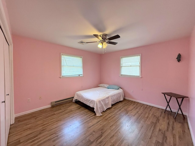 104 Sunset Dr, Mount Pocono, PA 18344 - bedroom featuring baseboard heating, wood finished floors, multiple windows, and visible vents