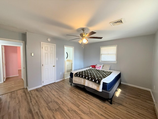 104 Sunset Dr, Mount Pocono, PA 18344 - bedroom with a ceiling fan, wood finished floors, baseboards, ensuite bath, and visible vents