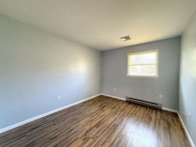 104 Sunset Dr, Mount Pocono, PA 18344 - spare room with baseboards, visible vents, baseboard heating, and dark wood-style flooring