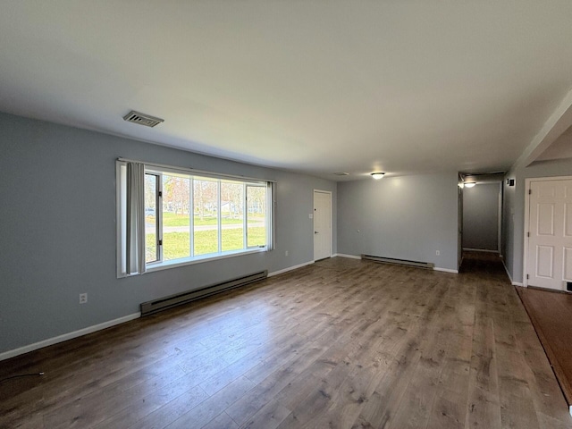 104 Sunset Dr, Mount Pocono, PA 18344 - unfurnished living room featuring wood finished floors, visible vents, and a baseboard radiator