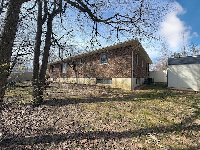 104 Sunset Dr, Mount Pocono, PA 18344 - view of side of home featuring an outbuilding, brick siding, and a shed
