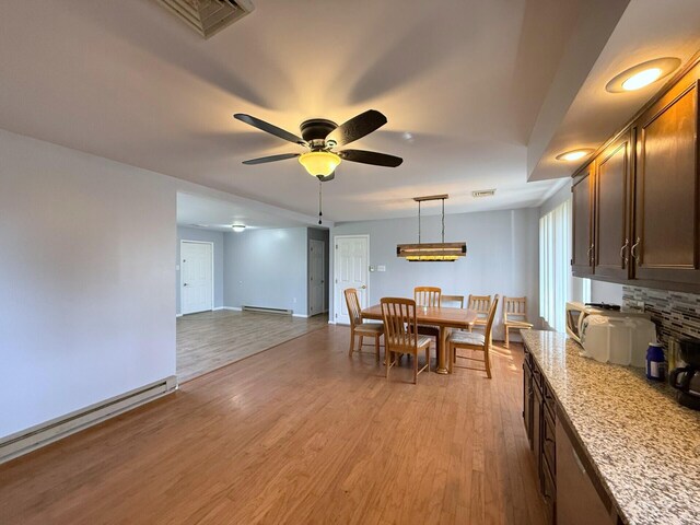 104 Sunset Dr, Mount Pocono, PA 18344 - dining space with baseboard heating, baseboards, a ceiling fan, and light wood-type flooring