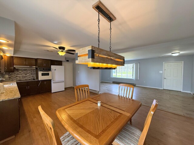 104 Sunset Dr, Mount Pocono, PA 18344 - dining area with baseboard heating, dark wood finished floors, baseboards, and ceiling fan