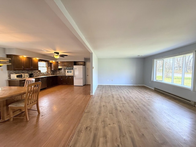 104 Sunset Dr, Mount Pocono, PA 18344 - unfurnished living room featuring plenty of natural light, light wood finished floors, and baseboard heating