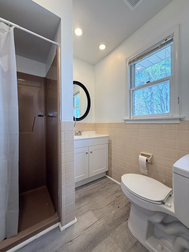 104 Sunset Dr, Mount Pocono, PA 18344 - bathroom with a shower stall, toilet, wainscoting, and tile walls