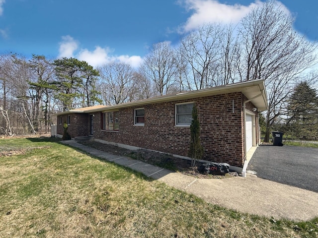 104 Sunset Dr, Mount Pocono, PA 18344 - view of front of property featuring a front lawn, brick siding, driveway, and a garage