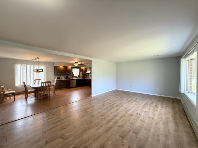 104 Sunset Dr, Mount Pocono, PA 18344 - unfurnished living room with a baseboard heating unit, baseboards, and wood finished floors