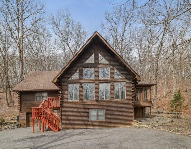 232 Stafford Dr, Bushkill, PA 18324 - back of house with log siding, stairs, and a deck