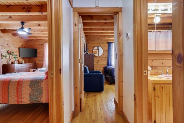 232 Stafford Dr, Bushkill, PA 18324 - hallway with wood walls, light wood-style flooring, and a sink
