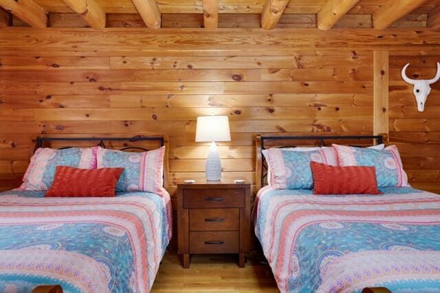 232 Stafford Dr, Bushkill, PA 18324 - bedroom featuring beamed ceiling, wood ceiling, and light wood-style floors