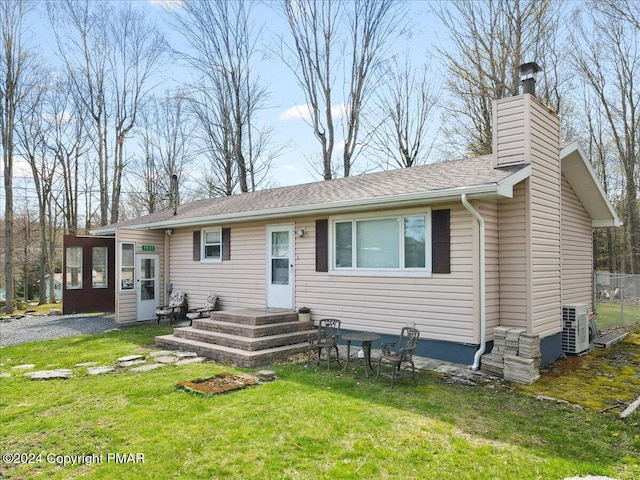 view of front of property with a chimney and a front lawn