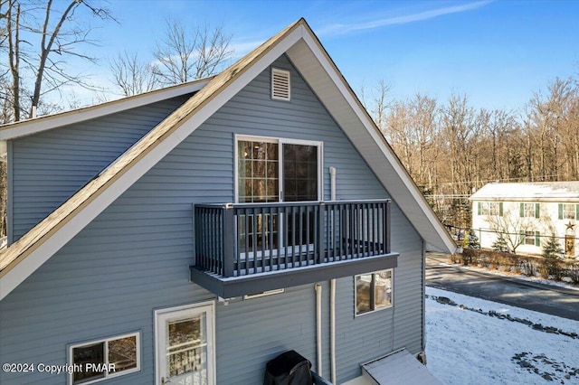 view of snowy exterior with a balcony