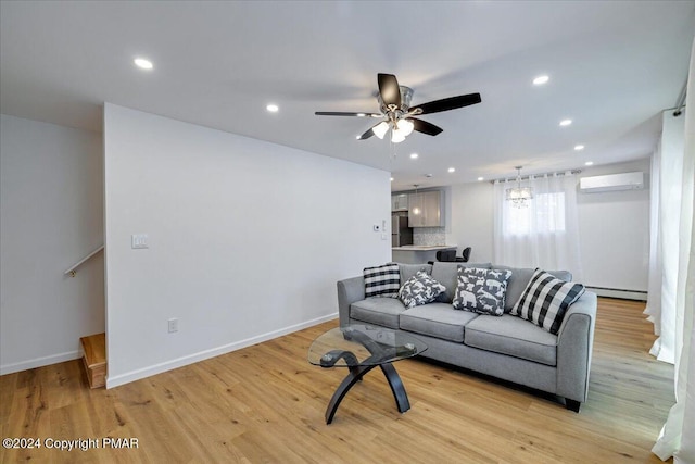 living area featuring recessed lighting, a baseboard heating unit, baseboards, light wood finished floors, and a wall mounted air conditioner