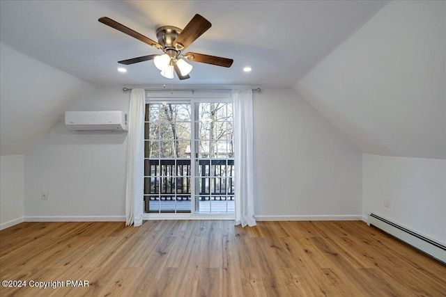 bonus room with baseboards, a baseboard radiator, wood finished floors, a wall mounted air conditioner, and vaulted ceiling