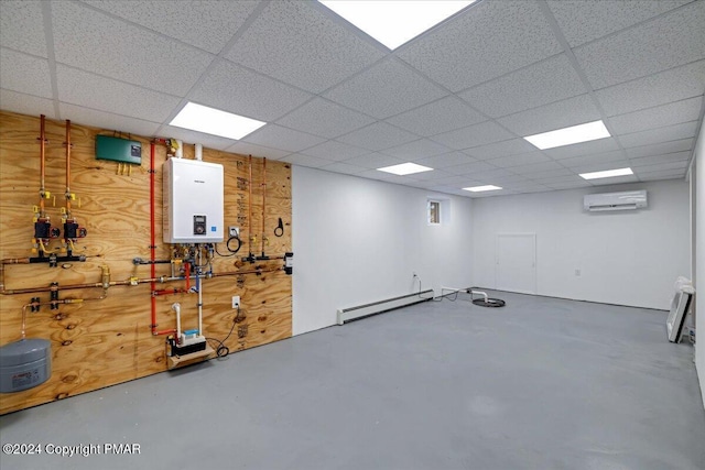 basement featuring a paneled ceiling, a baseboard heating unit, tankless water heater, and a wall mounted AC